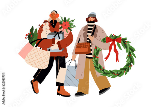 Women friends after Christmas shopping. Happy girls carrying winter holiday g...