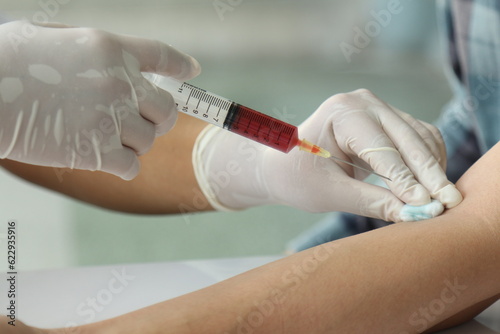 doctor with syringe blood puncture 