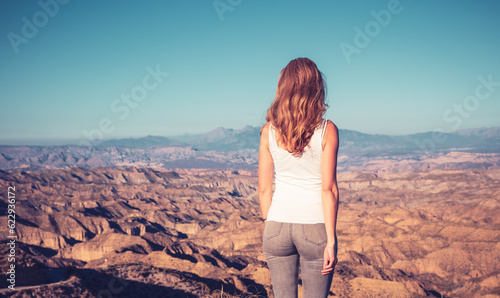 Woman standing looking at panoramic view of desert landscape- Gorafe in Spain