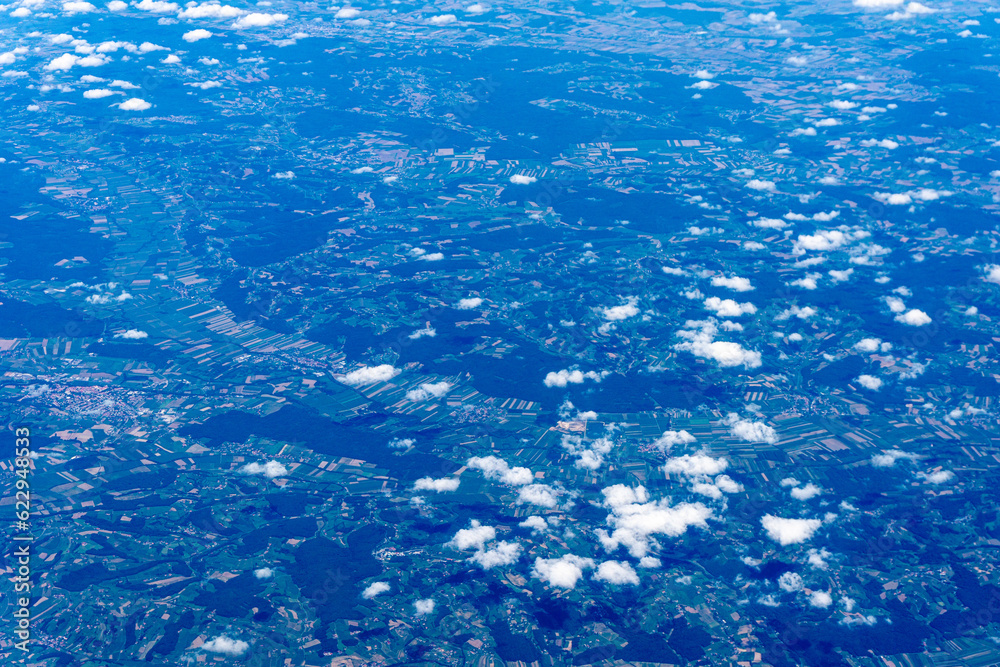 Fototapeta premium View to a land and clouds from airplane