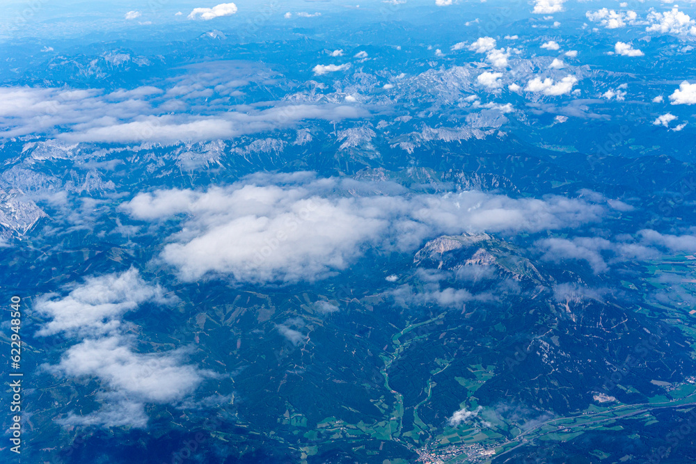 Fototapeta premium View to a land and clouds from airplane