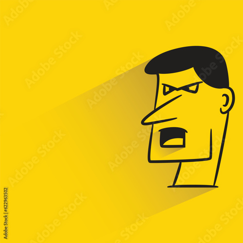 male face with shadow on yellow background