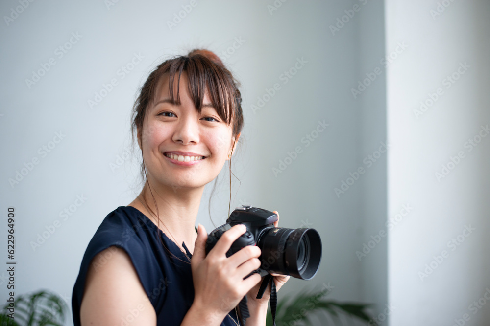 カメラを持って笑っている女性 カメラを持って笑っている女性