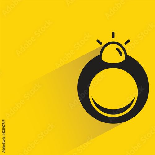 ring with shadow on yellow background