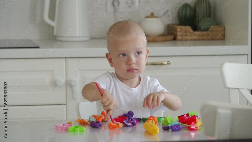 Toddler child playing with plasticine dough toy tools Toddler child playing with plasticine dough toy tools