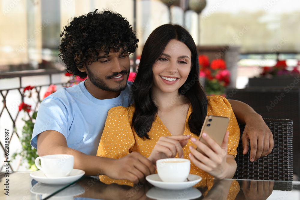 International dating. Happy couple spending time together in restaurant International dating. Happy couple spending time together in restaurant