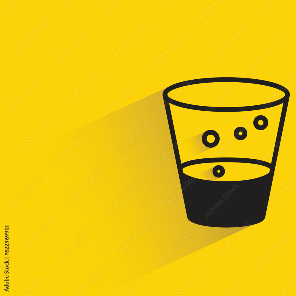 soda glass with shadow on yellow background