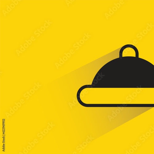 food dish with shadow on yellow background