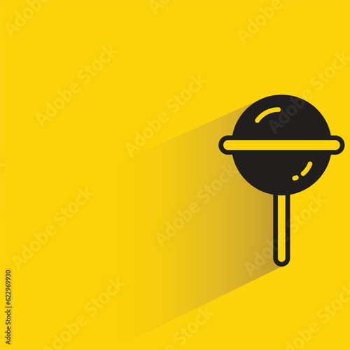 candy with shadow on yellow background