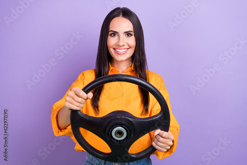 Photo of young satisfied girl professional steering wheel driver taxi owner fast speed road highway isolated on violet color background