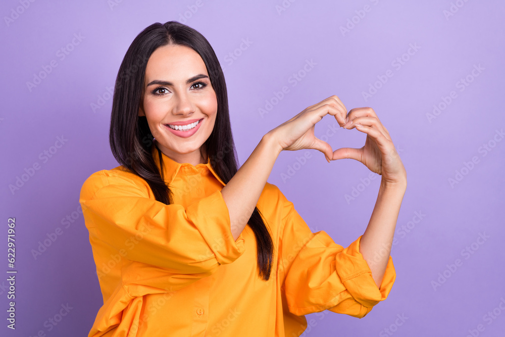 Portrait of good mood pretty woman with long hairstyle wear oversize shirt fingers showing heart symbol isolated on violet color background Portrait of good mood pretty woman with long hairstyle wear oversize shirt fingers showing heart symbol isolated on violet color background