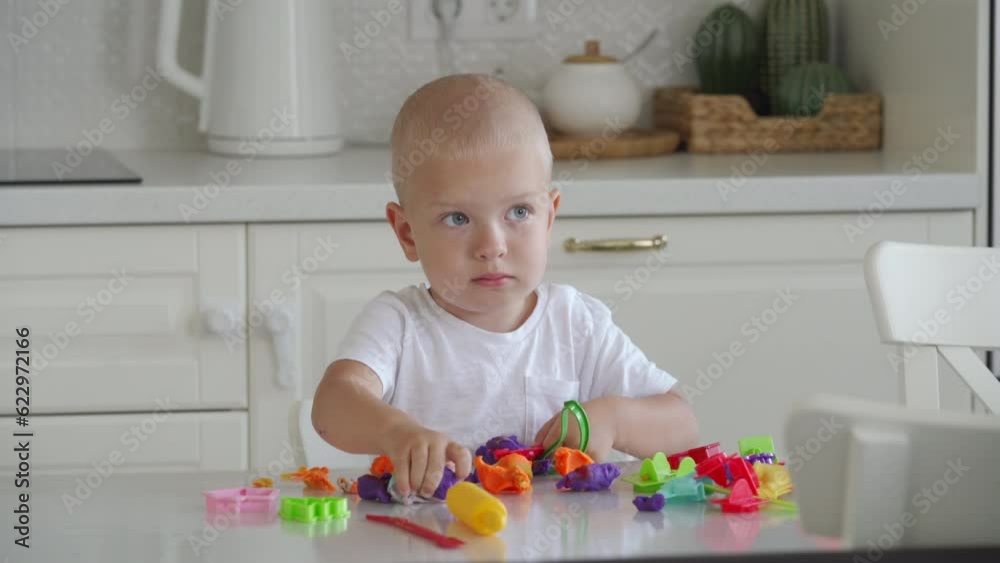Toddler child playing with plasticine dough toy tools Toddler child playing with plasticine dough toy tools