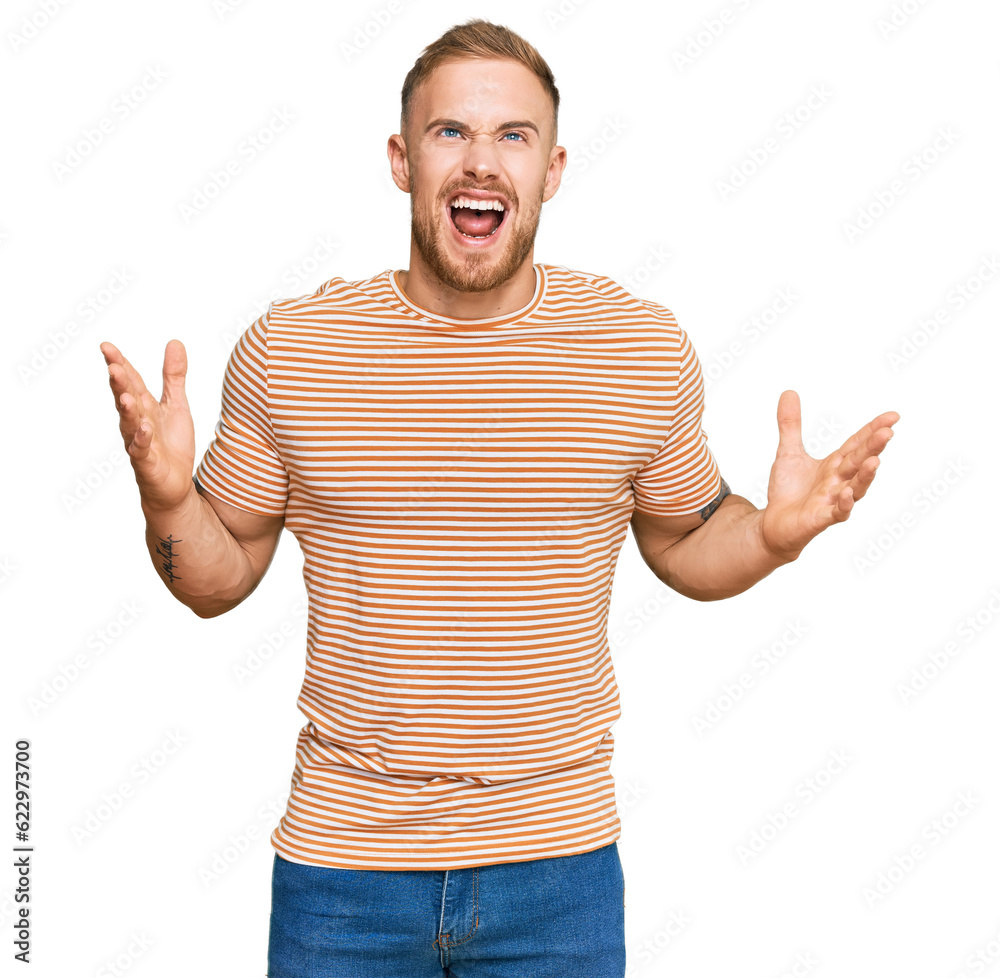 Young irish man wearing casual clothes crazy and mad shouting and yelling with aggressive expression and arms raised. frustration concept. Young irish man wearing casual clothes crazy and mad shouting and yelling with aggressive expression and arms raised. frustration concept.