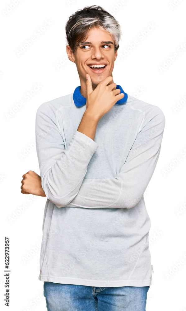 Young hispanic man wearing casual clothes with hand on chin thinking about question, pensive expression. smiling with thoughtful face. doubt concept. Young hispanic man wearing casual clothes with hand on chin thinking about question, pensive expression. smiling with thoughtful face. doubt concept.