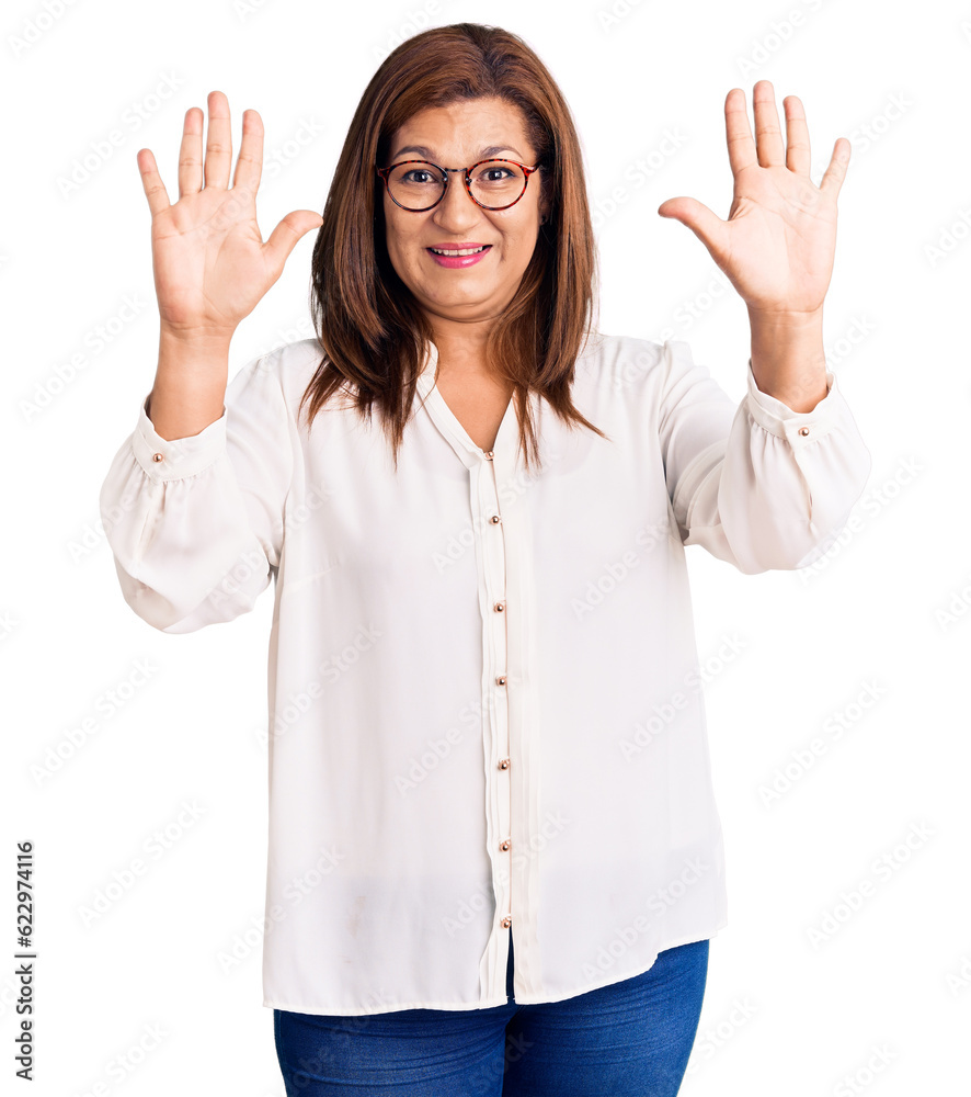 Middle age latin woman wearing casual clothes and glasses showing and pointing up with fingers number ten while smiling confident and happy. Middle age latin woman wearing casual clothes and glasses showing and pointing up with fingers number ten while smiling confident and happy.