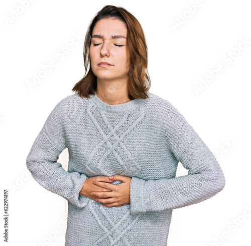 Young caucasian girl wearing casual clothes with hand on stomach because indigestion, painful illness feeling unwell. ache concept.