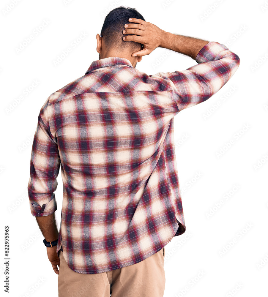 Young hispanic man wearing casual clothes and glasses backwards thinking about doubt with hand on head Young hispanic man wearing casual clothes and glasses backwards thinking about doubt with hand on head