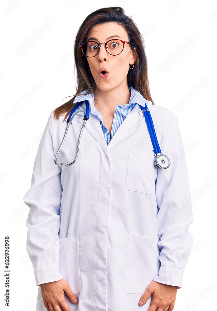 Young beautiful woman wearing doctor stethoscope and glasses afraid and shocked with surprise expression, fear and excited face. Young beautiful woman wearing doctor stethoscope and glasses afraid and shocked with surprise expression, fear and excited face.