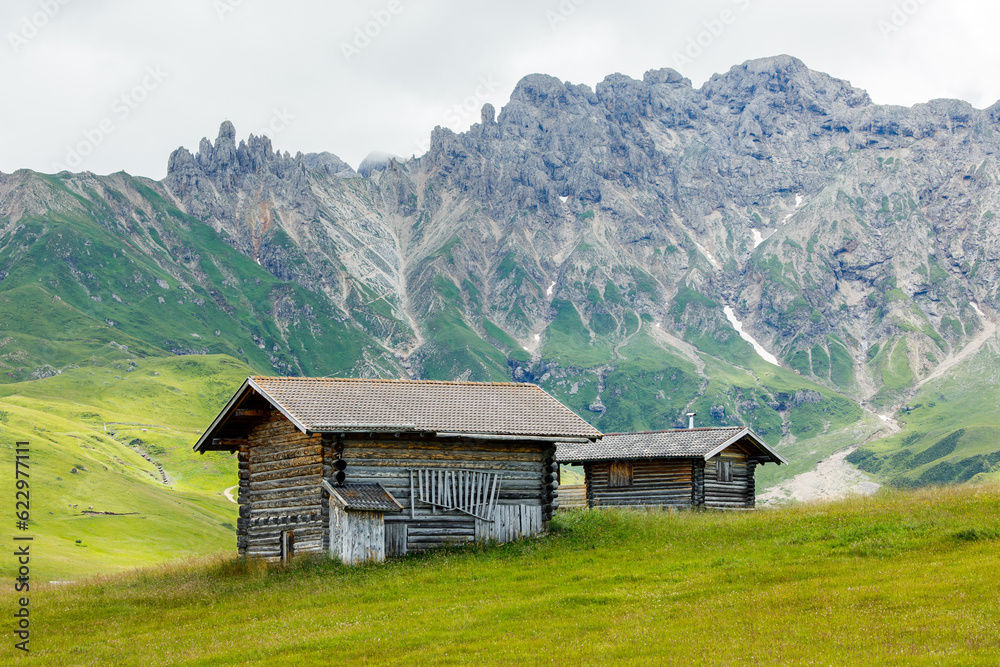 Huts in the valley of Alpe di Suisi mountains in South Tyrol, Italy.