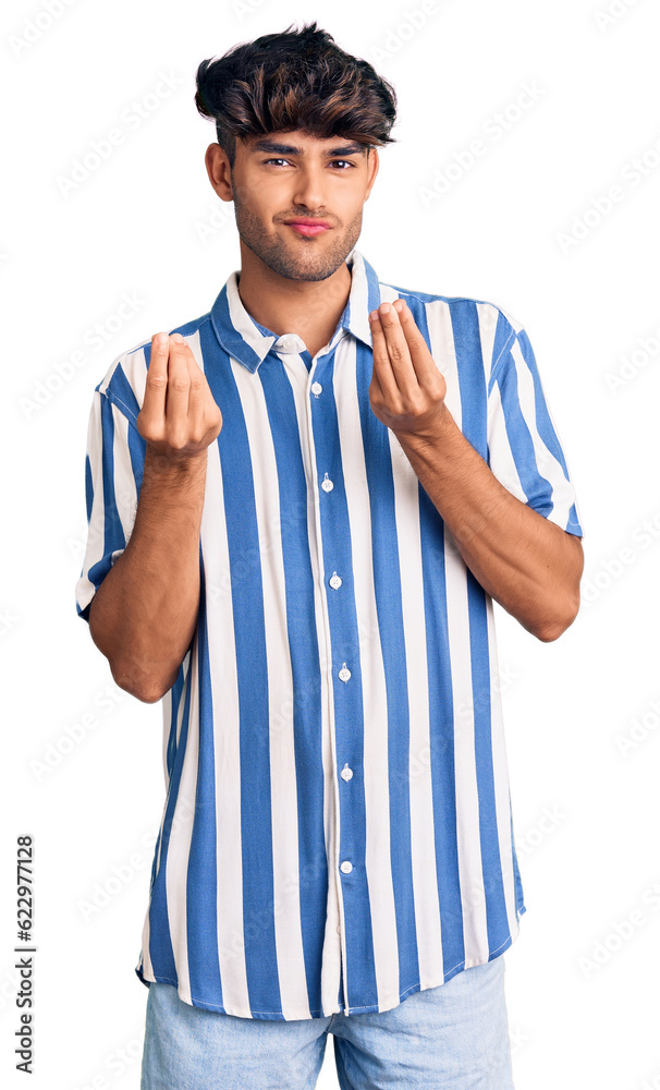 Young hispanic man wearing casual clothes doing money gesture with hands, asking for salary payment, millionaire business