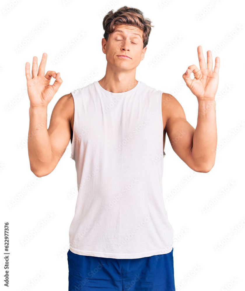 Young handsome man wearing sleveeless t shirt relax and smiling with eyes closed doing meditation gesture with fingers. yoga concept. Young handsome man wearing sleveeless t shirt relax and smiling with eyes closed doing meditation gesture with fingers. yoga concept.