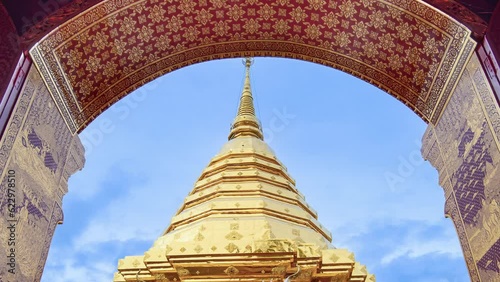 Wat Phra That Doi Suthep and beautiful patterned red door against the blue sky and white clouds. Famous Temple of Chiang Mai, Thailand. 4K Zoom Out Shot.