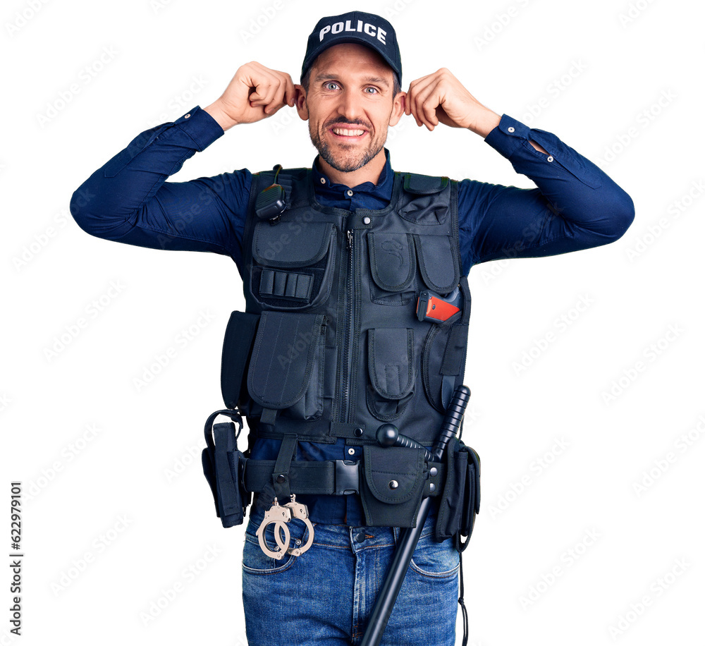 Young handsome man wearing police uniform smiling pulling ears with fingers, funny gesture. audition problem Young handsome man wearing police uniform smiling pulling ears with fingers, funny gesture. audition problem