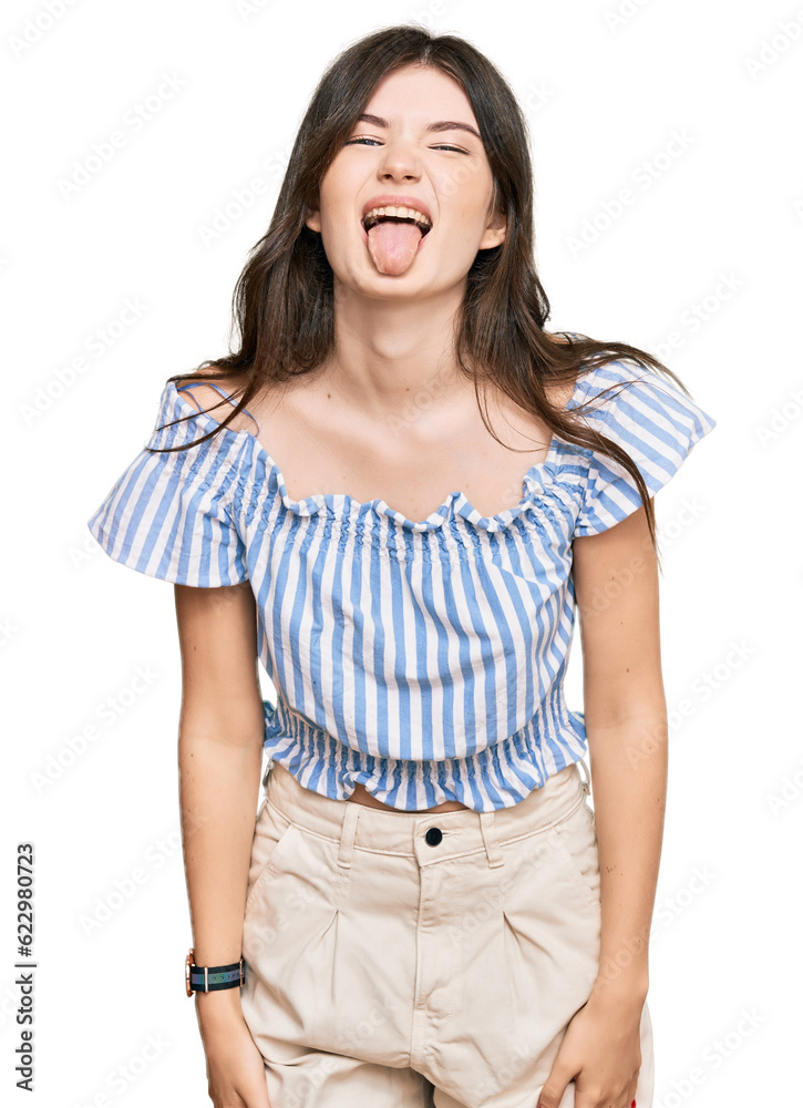 Obraz premium Young beautiful caucasian girl wearing casual clothes sticking tongue out happy with funny expression. emotion concept.