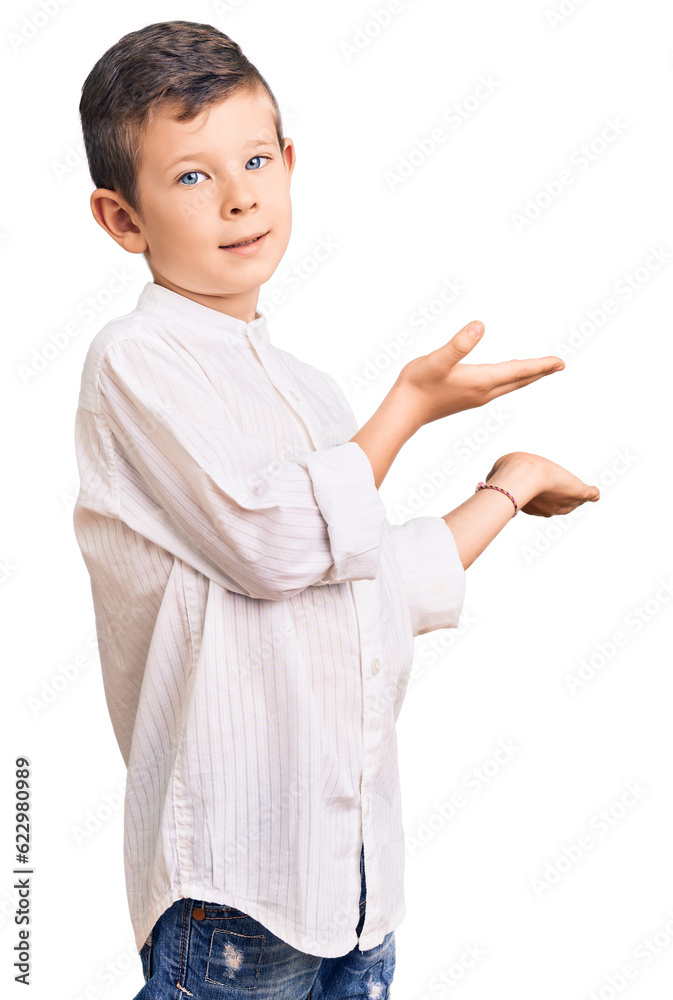 Cute blond kid wearing elegant shirt inviting to enter smiling natural with open hand Cute blond kid wearing elegant shirt inviting to enter smiling natural with open hand