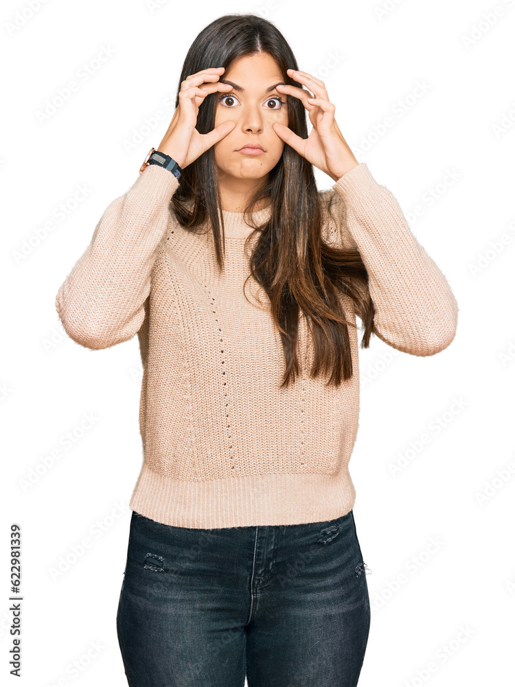 Young brunette woman wearing casual winter sweater trying to open eyes with fingers, sleepy and tired for morning fatigue Young brunette woman wearing casual winter sweater trying to open eyes with fingers, sleepy and tired for morning fatigue