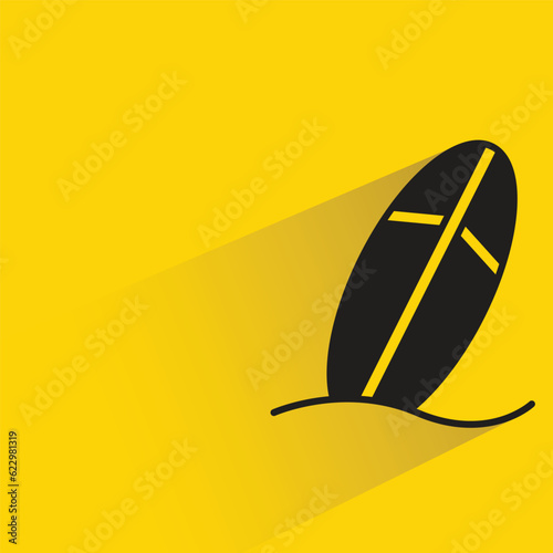 surfboard with shadow on yellow background