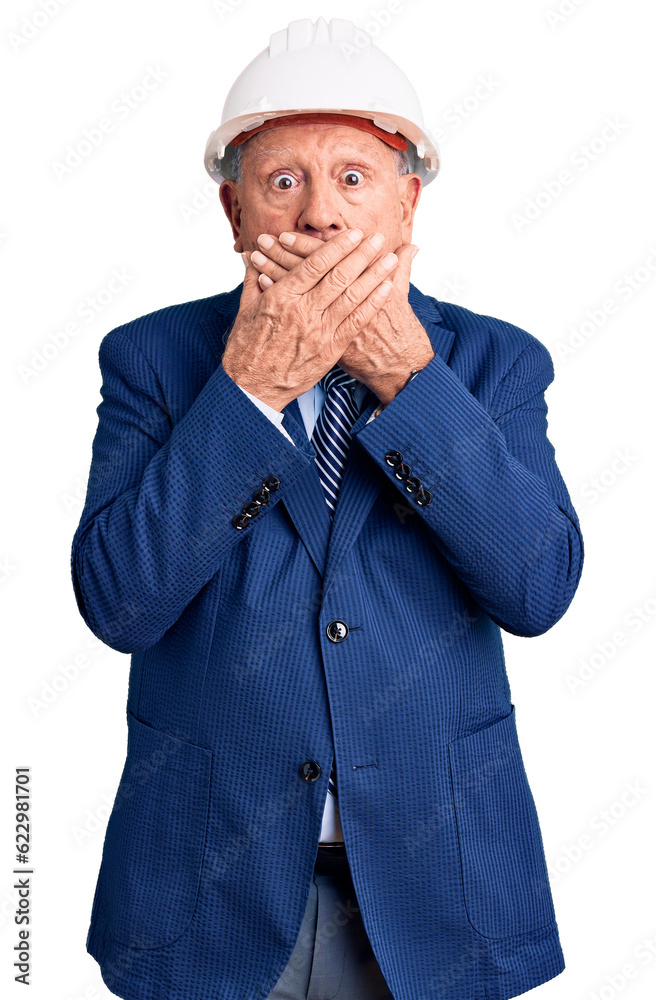Senior handsome grey-haired man wearing suit and architect hardhat shocked covering mouth with hands for mistake. secret concept. Senior handsome grey-haired man wearing suit and architect hardhat shocked covering mouth with hands for mistake. secret concept.