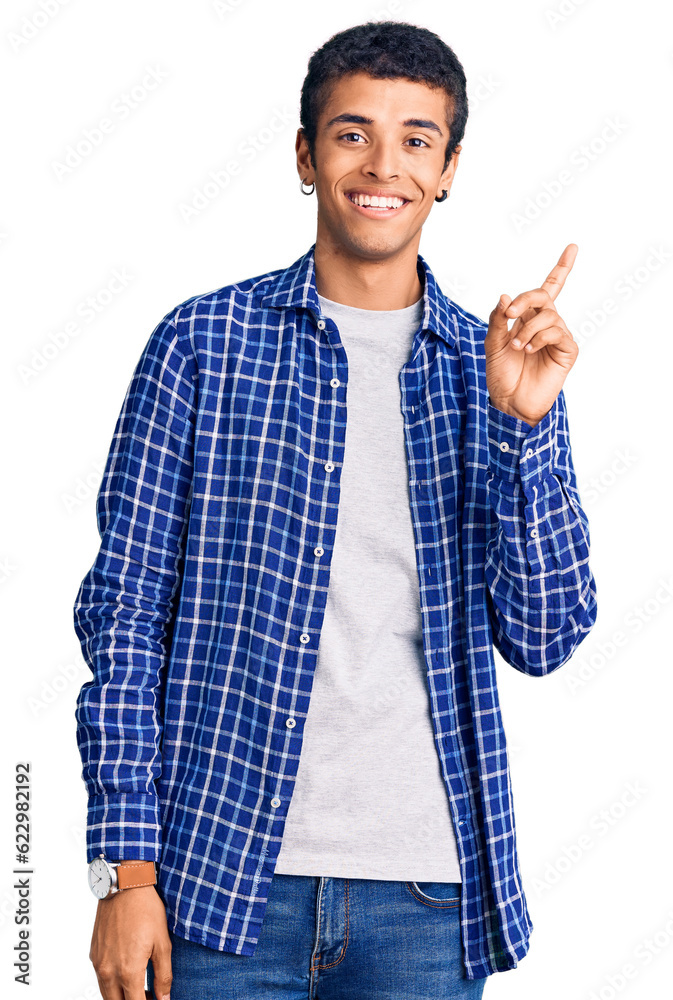 Young african amercian man wearing casual clothes with a big smile on face, pointing with hand finger to the side looking at the camera. Young african amercian man wearing casual clothes with a big smile on face, pointing with hand finger to the side looking at the camera.