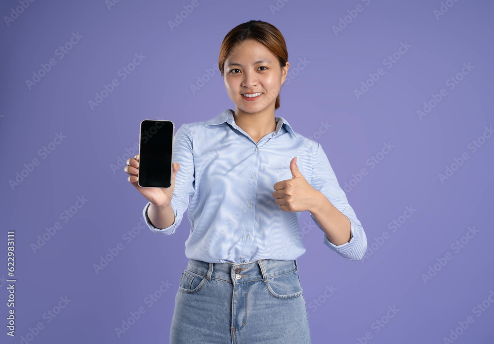 image of young asian business girl using phone on purple background image of young asian business girl using phone on purple background