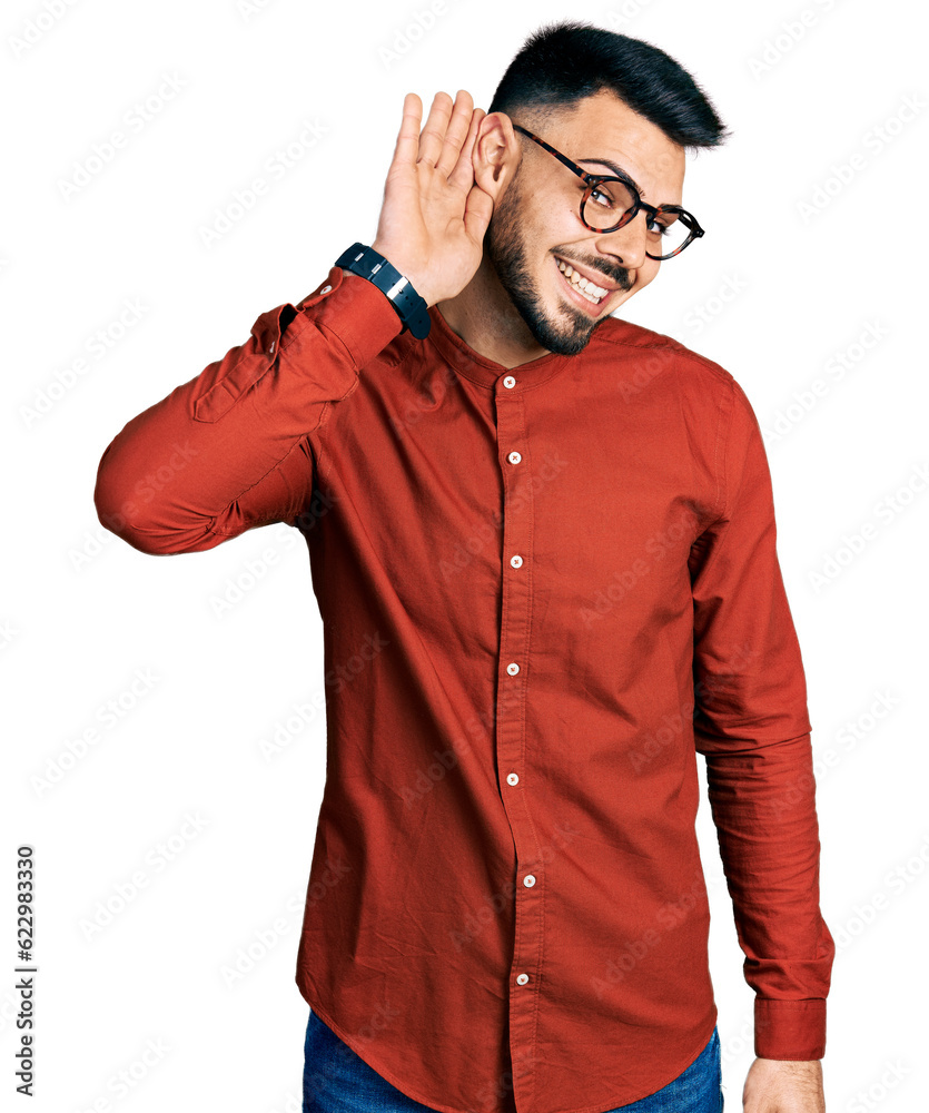 Young hispanic man with beard wearing business shirt and glasses smiling with hand over ear listening an hearing to rumor or gossip. deafness concept.