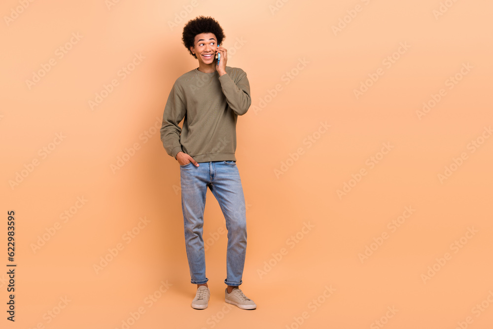 Full body length size photo of young business man important conversation talk phone look empty space proposition isolated on beige color background Full body length size photo of young business man important conversation talk phone look empty space proposition isolated on beige color background