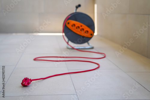Power extension cable reel, professional electrical equipment, selective focus to cable, reel is blurred