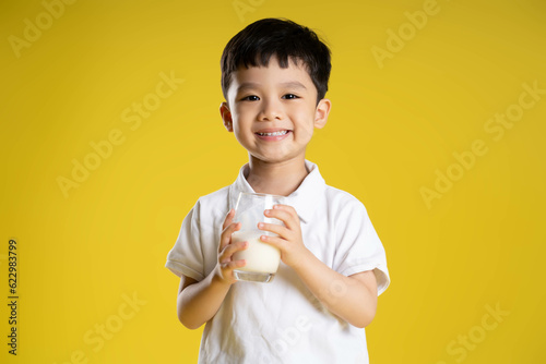 image of asian boy posing on a yellow background.