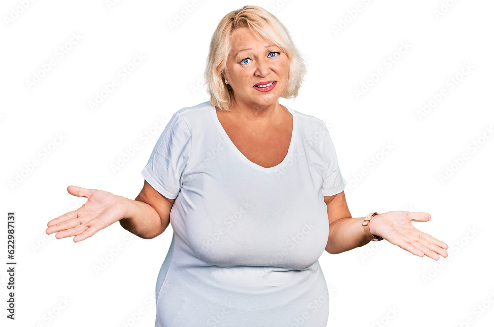 Middle age blonde woman wearing casual white t shirt clueless and confused with open arms, no idea concept. Middle age blonde woman wearing casual white t shirt clueless and confused with open arms, no idea concept.