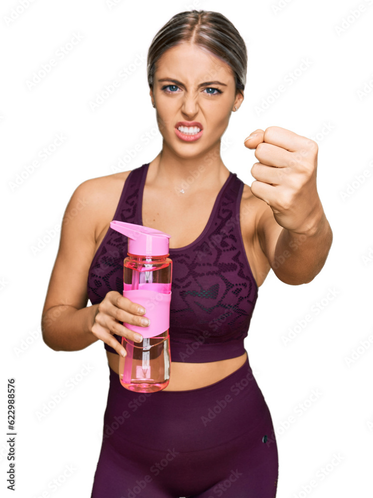 Beautiful blonde woman wearing sportswear holding water bottle annoyed and frustrated shouting with anger, yelling crazy with anger and hand raised Beautiful blonde woman wearing sportswear holding water bottle annoyed and frustrated shouting with anger, yelling crazy with anger and hand raised