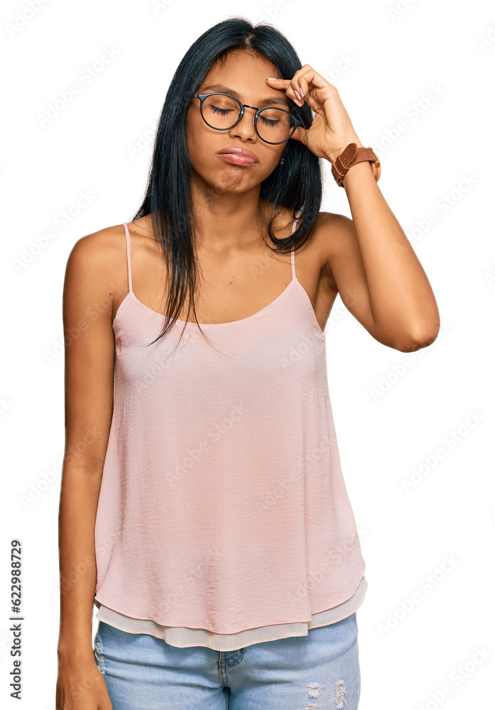 Young african american woman wearing casual clothes and glasses worried and stressed about a problem with hand on forehead, nervous and anxious for crisis
