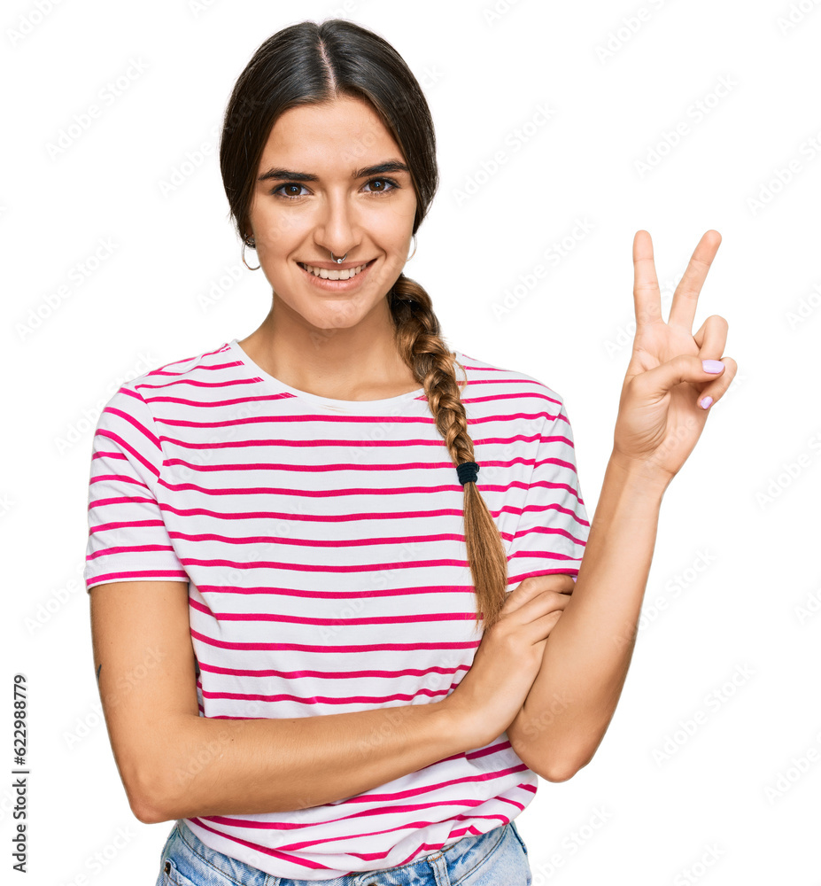 Young hispanic woman wearing casual clothes smiling with happy face winking at the camera doing victory sign. number two. Young hispanic woman wearing casual clothes smiling with happy face winking at the camera doing victory sign. number two.