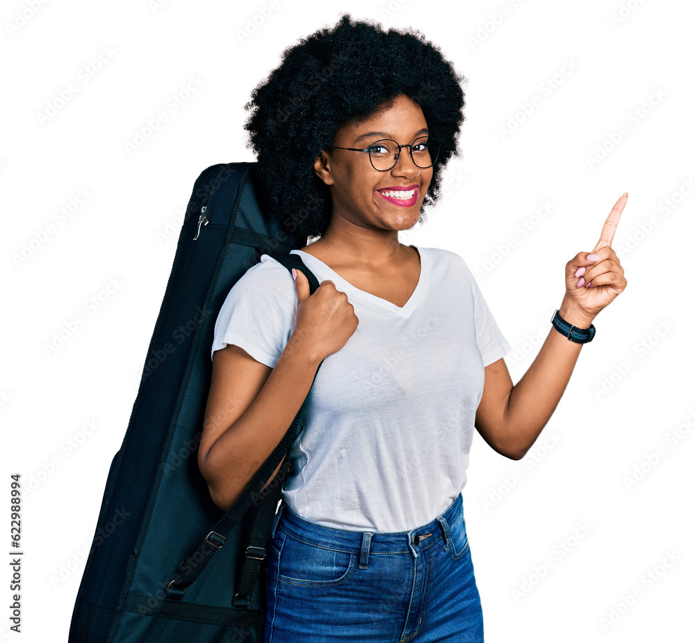 Young african american woman wearing guitar case smiling happy pointing with hand and finger to the side Young african american woman wearing guitar case smiling happy pointing with hand and finger to the side