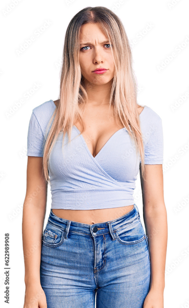 Young beautiful blonde woman wearing casual clothes skeptic and nervous, frowning upset because of problem. negative person. Young beautiful blonde woman wearing casual clothes skeptic and nervous, frowning upset because of problem. negative person.