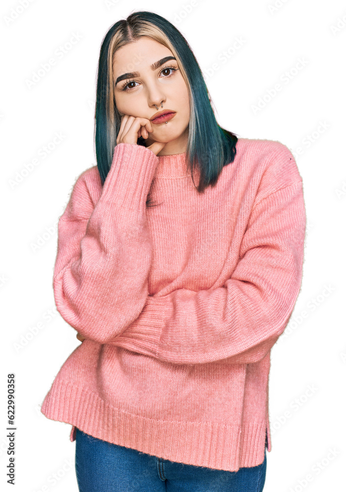 Young modern girl wearing pink wool winter sweater thinking looking tired and bored with depression problems with crossed arms. Young modern girl wearing pink wool winter sweater thinking looking tired and bored with depression problems with crossed arms.