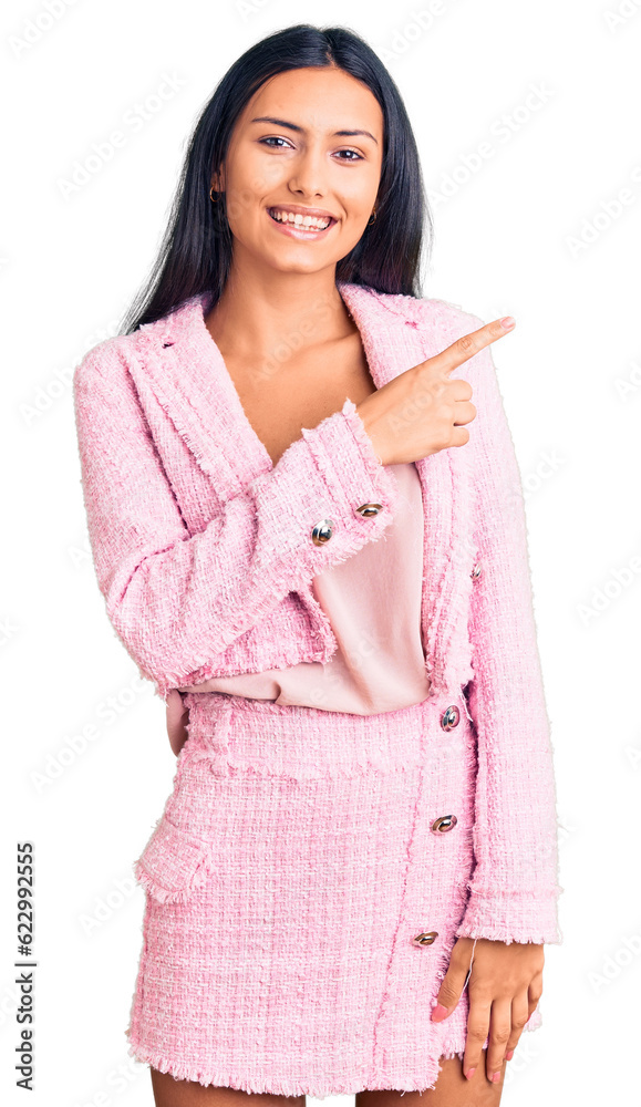 Young beautiful latin girl wearing business clothes cheerful with a smile on face pointing with hand and finger up to the side with happy and natural expression Young beautiful latin girl wearing business clothes cheerful with a smile on face pointing with hand and finger up to the side with happy and natural expression