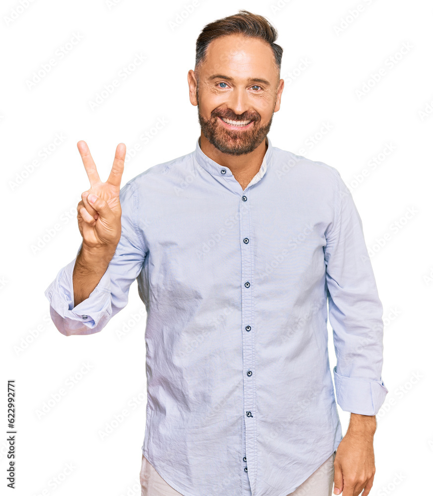 Handsome middle age man wearing business shirt showing and pointing up with fingers number two while smiling confident and happy. Handsome middle age man wearing business shirt showing and pointing up with fingers number two while smiling confident and happy.