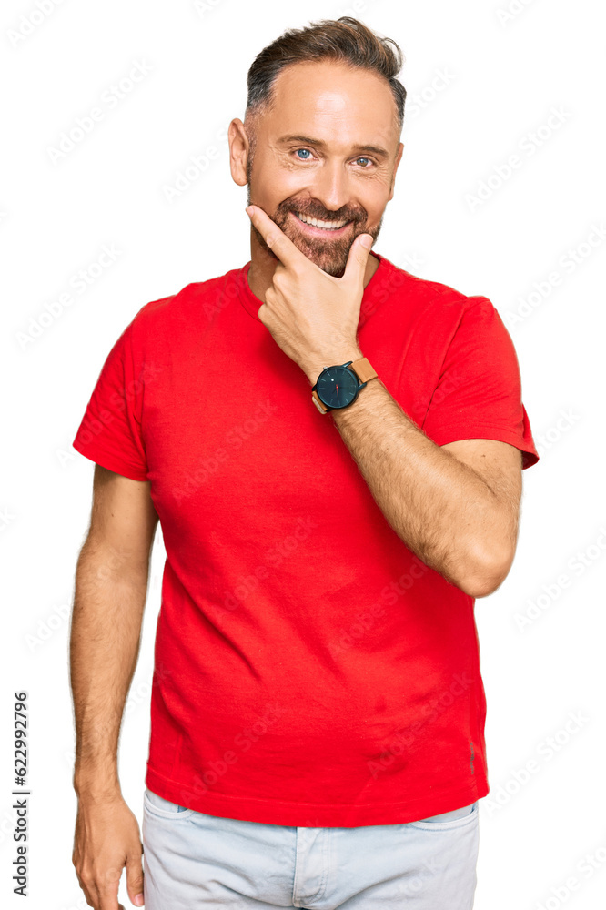 Handsome middle age man wearing casual red tshirt looking confident at the camera smiling with crossed arms and hand raised on chin. thinking positive. Handsome middle age man wearing casual red tshirt looking confident at the camera smiling with crossed arms and hand raised on chin. thinking positive.