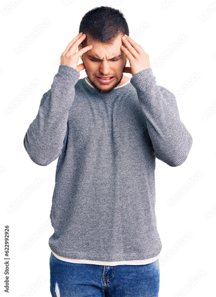 Naklejka premium Young handsome man wearing casual sweater with hand on head for pain in head because stress. suffering migraine.