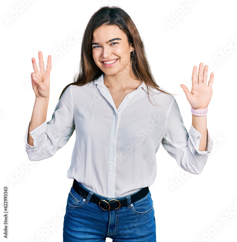 Young caucasian girl wearing casual white shirt showing and pointing up with fingers number eight while smiling confident and happy.